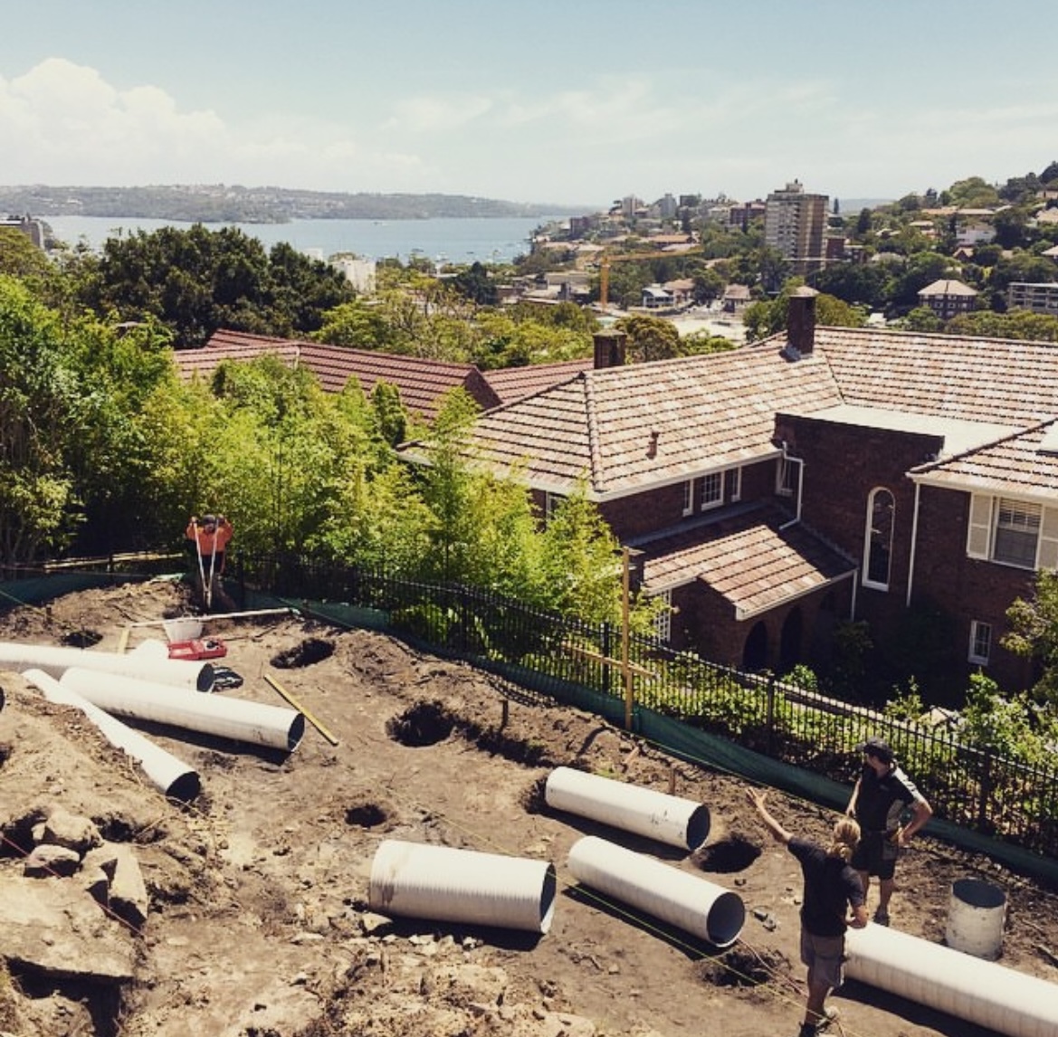 Excavated hillside site during lap pool construction