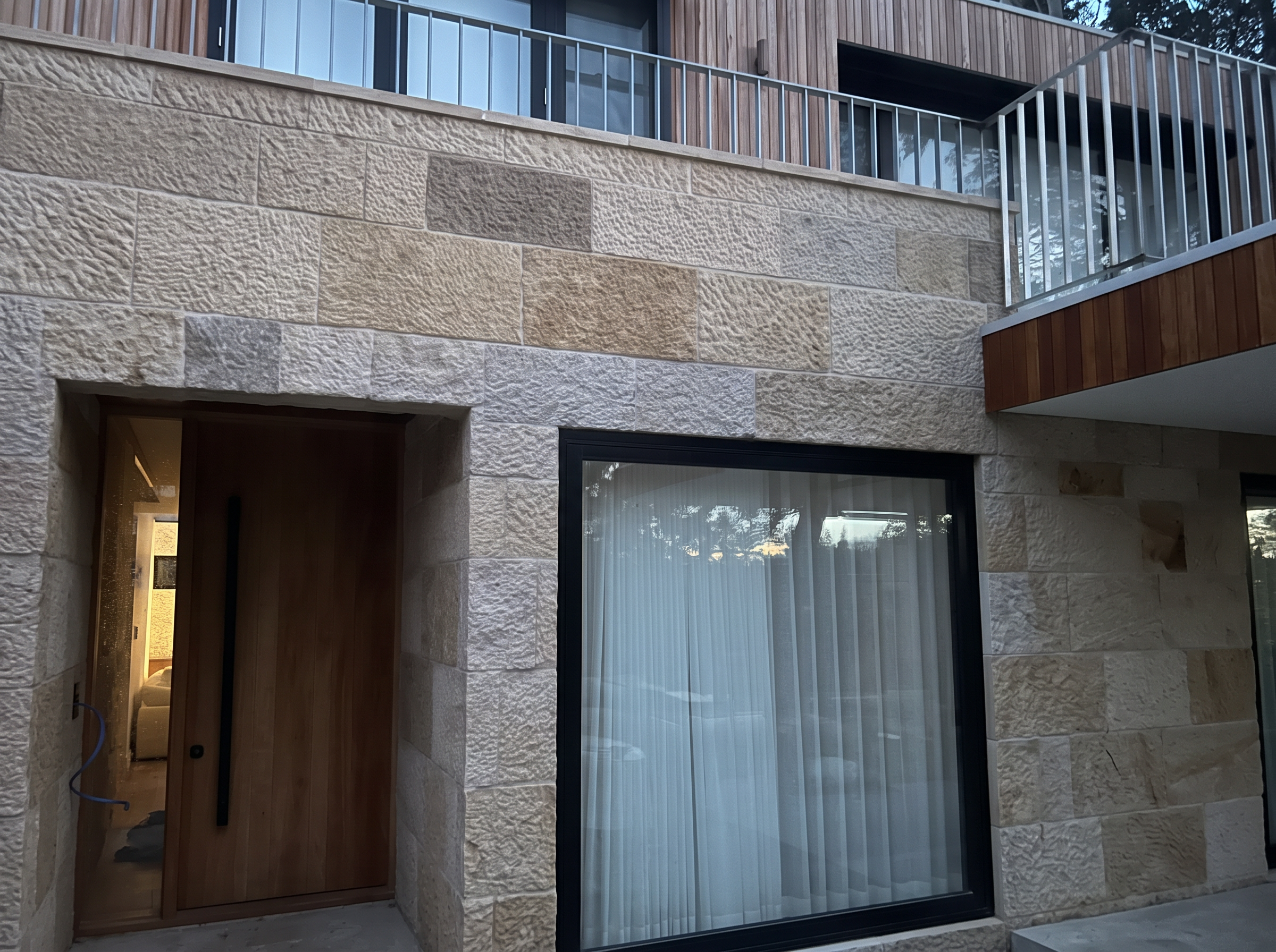 Sparrow-picked sandstone block facade