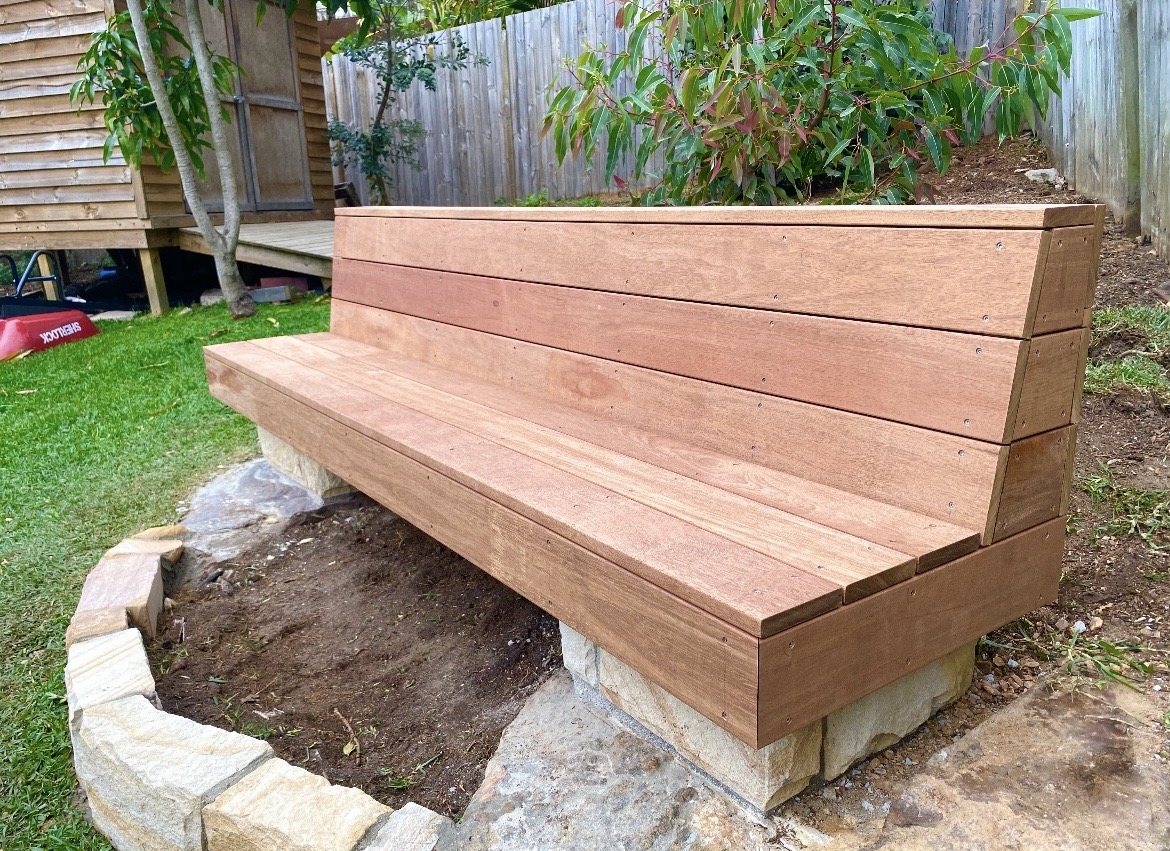 Hardwood bench on sandstone base