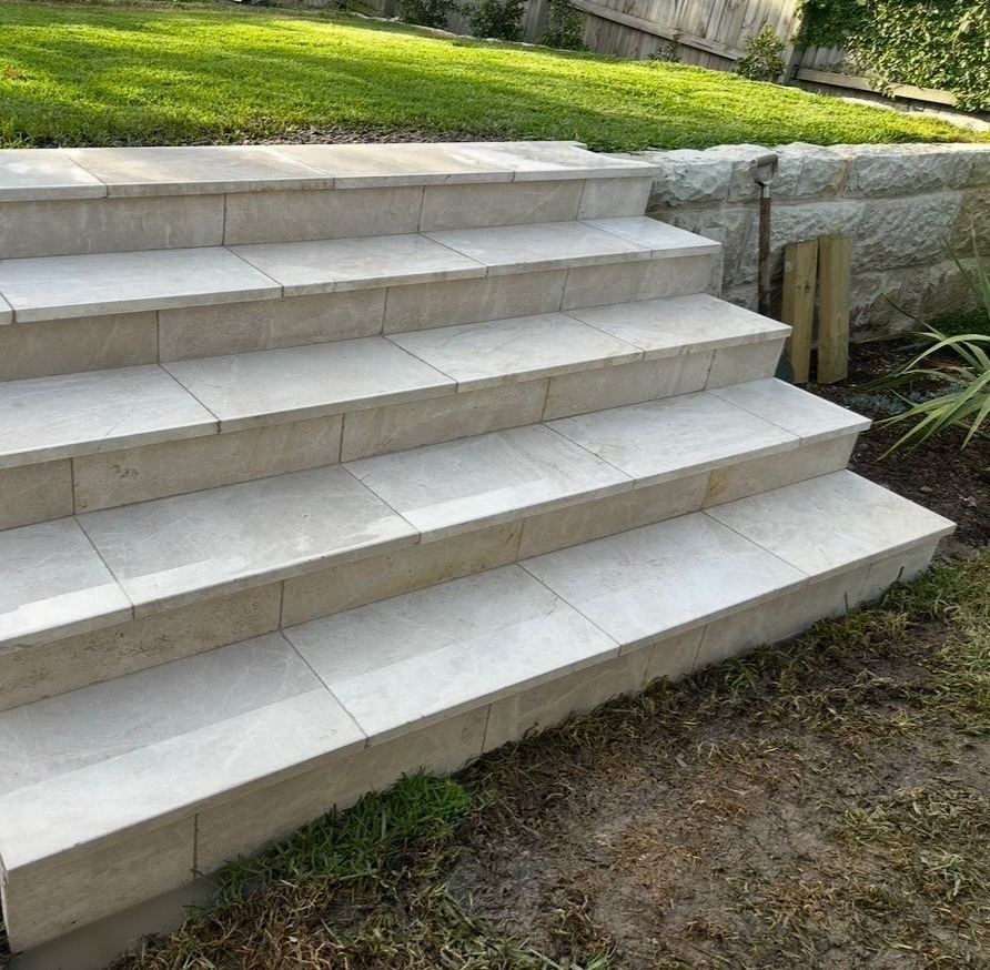 Finished stone steps with sandstone retaining wall and new lawn